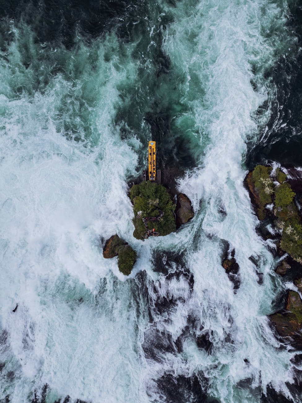 A breathtaking aerial view of the Rhine Falls showing cascading waters and lush greenery.